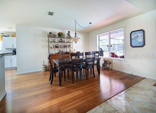 dining area with visible vents and light wood finished floors