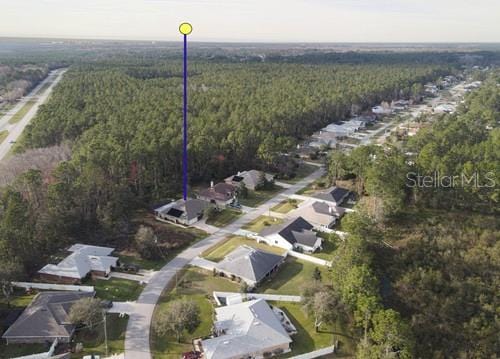 bird's eye view featuring a wooded view