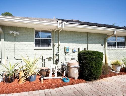 view of side of home featuring brick siding