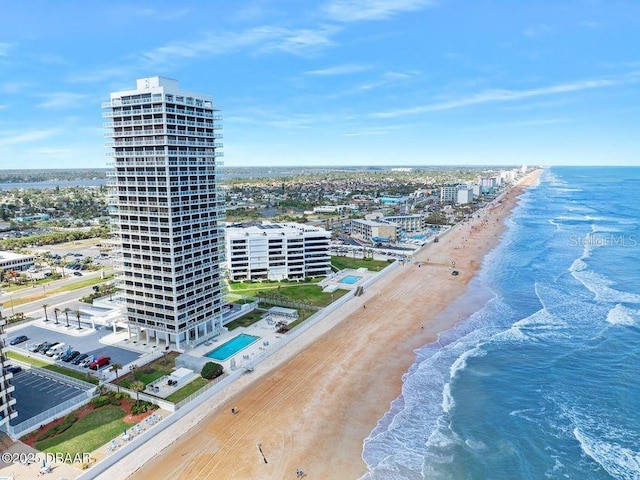 birds eye view of property with a view of the beach, a water view, and a view of city