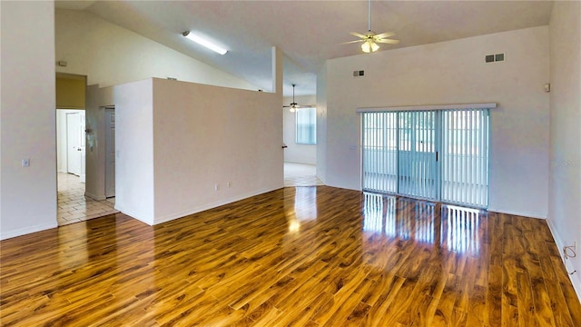 unfurnished room with high vaulted ceiling, ceiling fan, visible vents, and wood finished floors