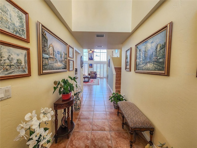 hall with visible vents and tile patterned floors