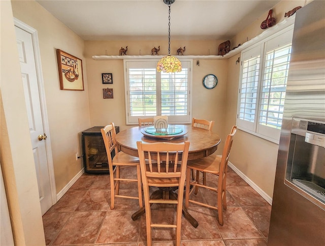 dining space with tile patterned flooring and baseboards