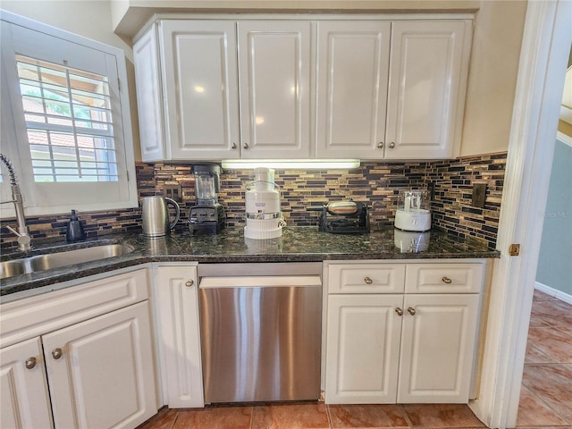 kitchen with dishwasher, backsplash, a sink, and white cabinetry