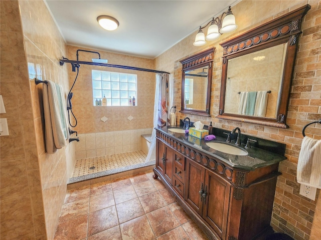 full bathroom featuring double vanity, a sink, and tiled shower