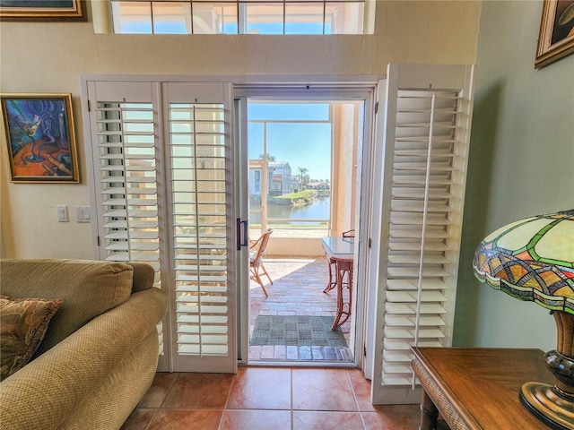 entryway with tile patterned flooring and a water view