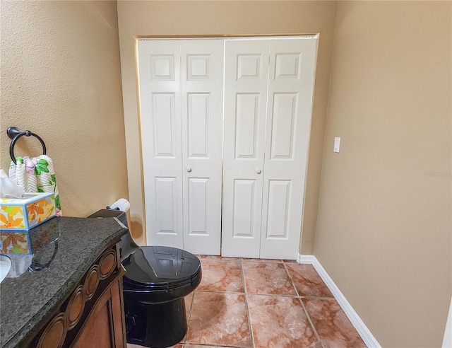 bathroom featuring vanity, baseboards, and tile patterned floors