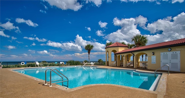 pool featuring a patio area and fence