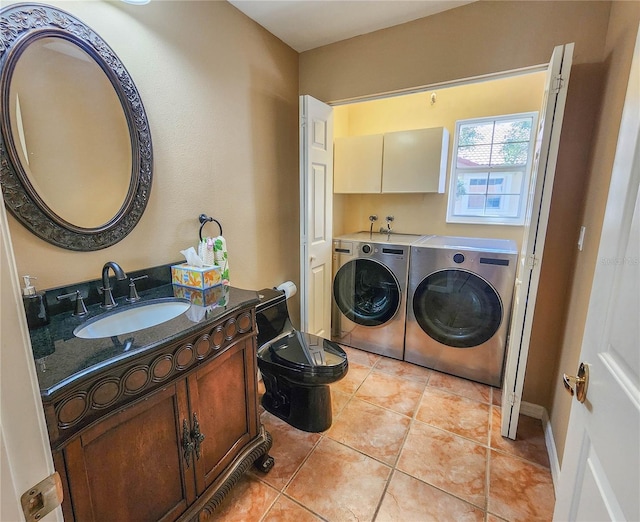 bathroom with toilet, washer and clothes dryer, vanity, and tile patterned floors