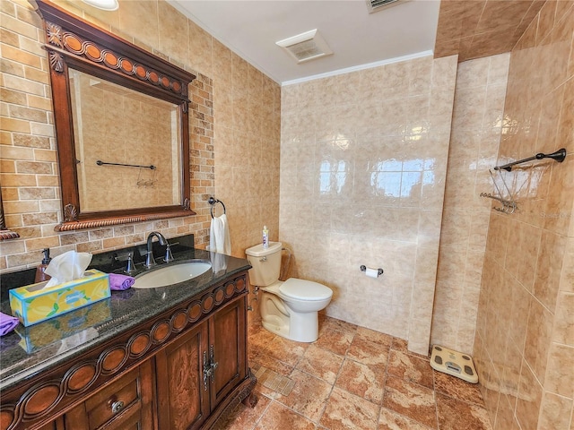 bathroom with toilet, ornamental molding, vanity, a walk in shower, and tile walls