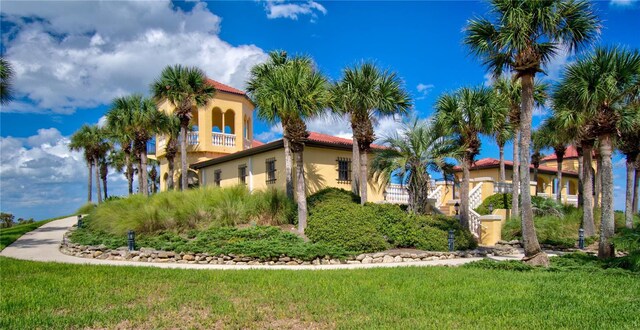 view of side of property with a lawn and stucco siding