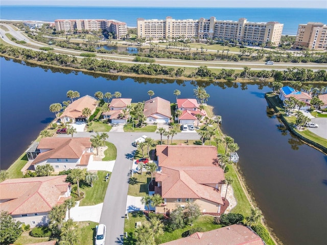 birds eye view of property with a view of city and a water view