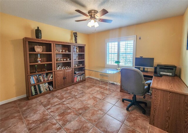 tiled office space featuring ceiling fan, baseboards, and a textured ceiling