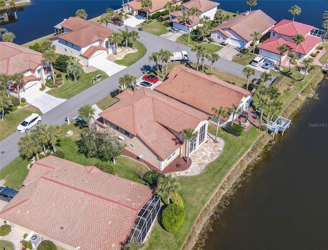 bird's eye view with a water view and a residential view