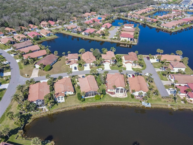 bird's eye view featuring a water view and a residential view