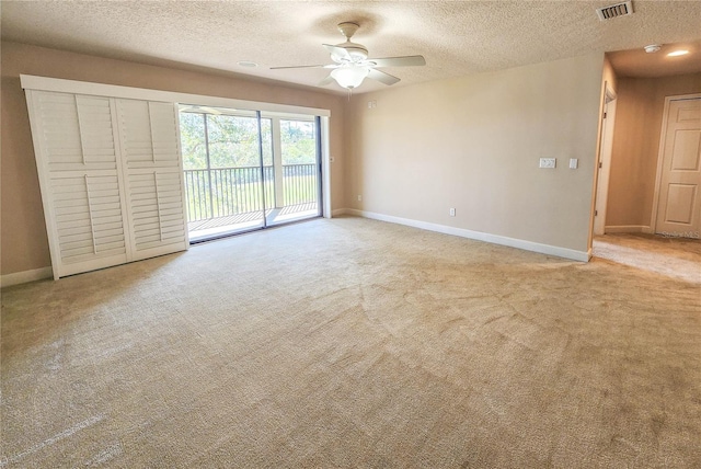 empty room featuring light carpet, visible vents, and baseboards