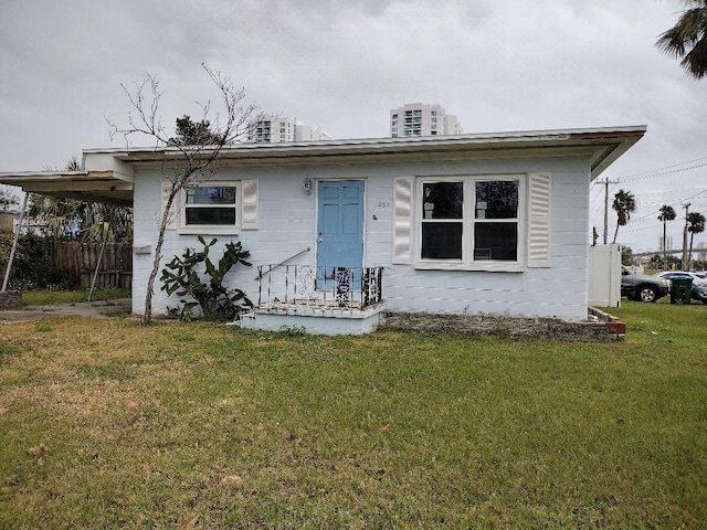 bungalow with a carport and a front yard