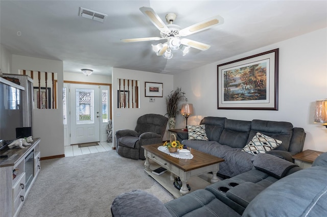 living area with a ceiling fan, light colored carpet, and visible vents