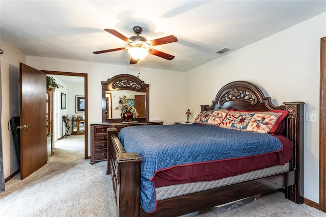 bedroom featuring a ceiling fan, light carpet, visible vents, and baseboards