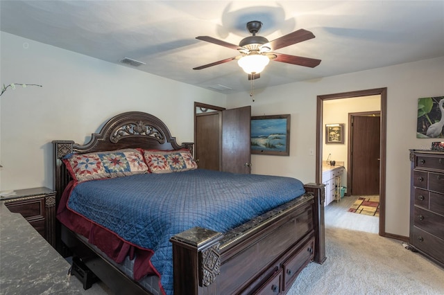 bedroom featuring ceiling fan, visible vents, and light colored carpet