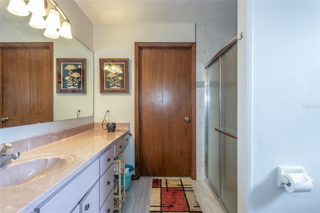 full bathroom with a stall shower and vanity