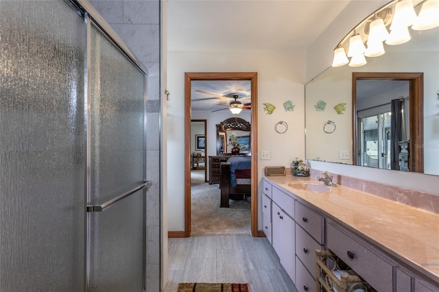 bathroom with a stall shower, ensuite bath, a ceiling fan, and vanity