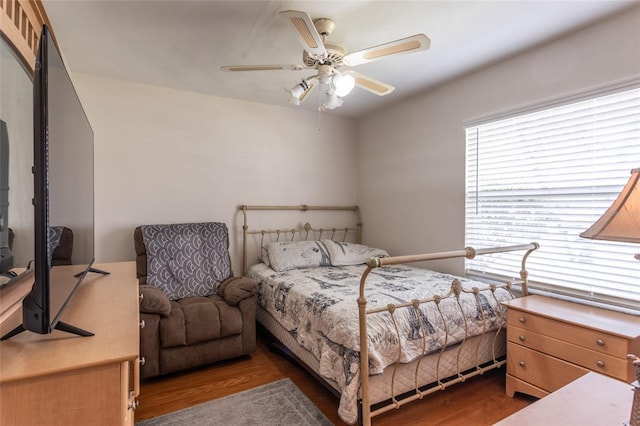 bedroom featuring a ceiling fan and dark wood finished floors