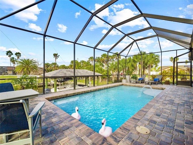 pool with a patio area and glass enclosure