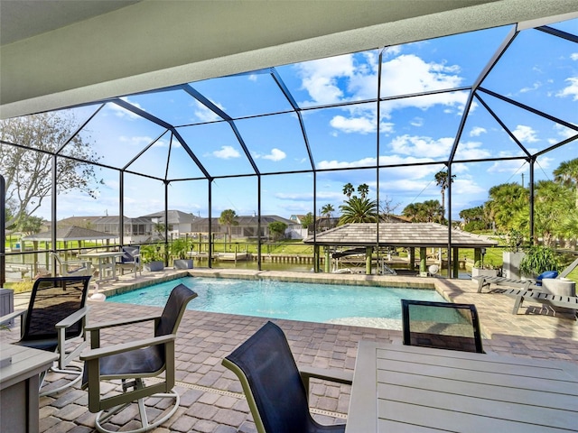 pool with a patio, a lanai, and a residential view