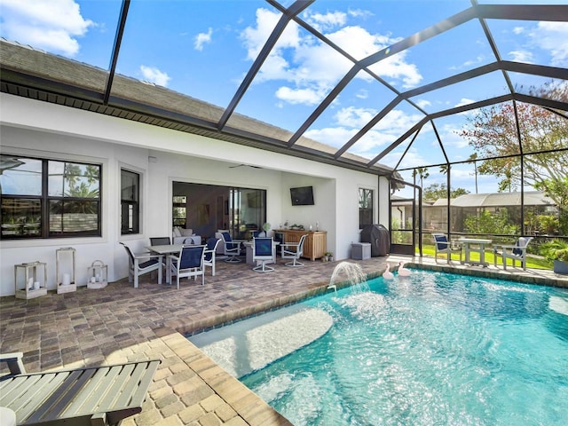 outdoor pool with a lanai and a patio area