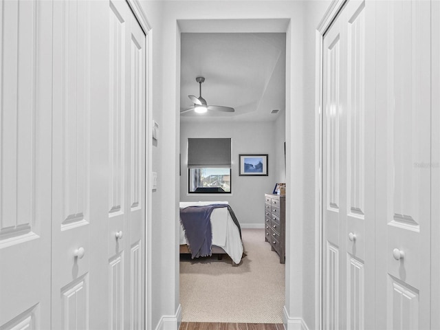 hallway with light carpet and baseboards