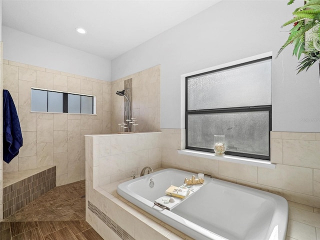 bathroom featuring a walk in shower, a garden tub, and recessed lighting