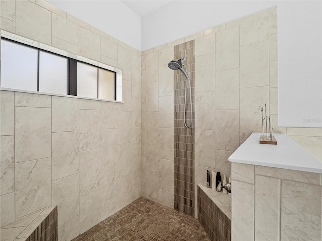 bathroom with visible vents and a tile shower