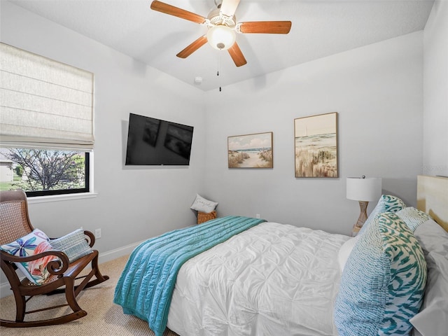 carpeted bedroom featuring a ceiling fan and baseboards