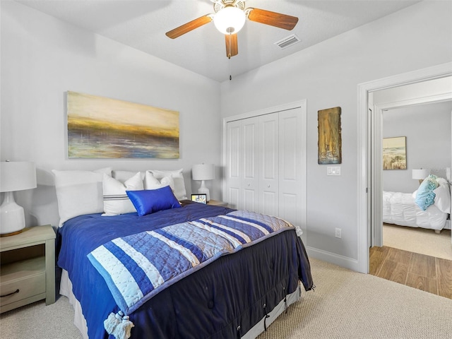 bedroom with carpet, a closet, visible vents, a ceiling fan, and baseboards