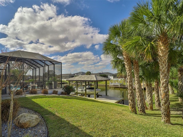 view of dock with a water view, a lawn, and boat lift