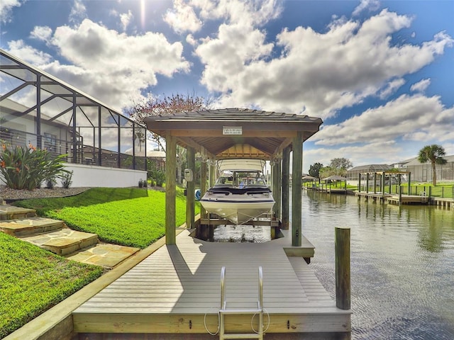 view of dock featuring a water view, glass enclosure, boat lift, and a yard