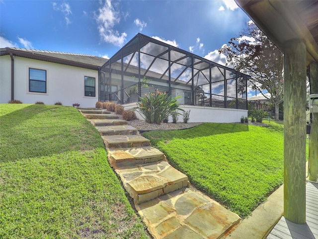 back of house with glass enclosure, a yard, and stucco siding