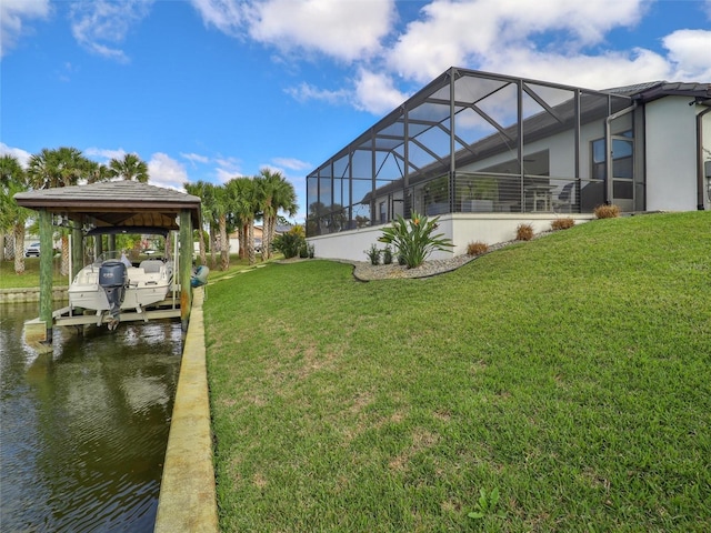 view of dock featuring a lanai, a water view, boat lift, and a lawn