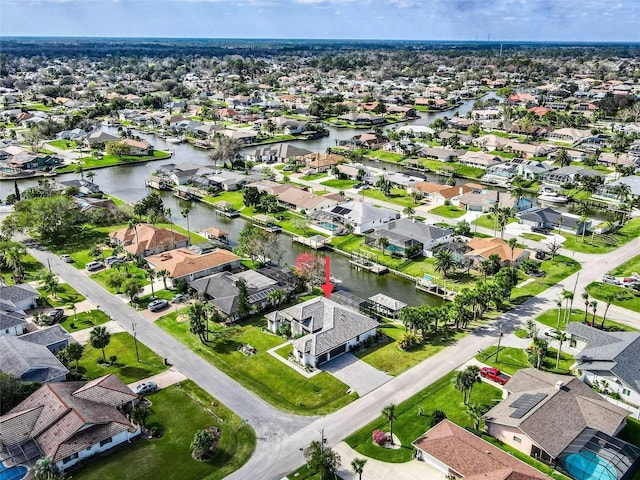 bird's eye view featuring a residential view and a water view