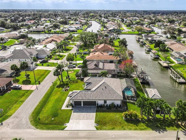 drone / aerial view with a water view and a residential view