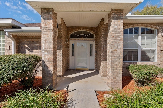 property entrance featuring brick siding