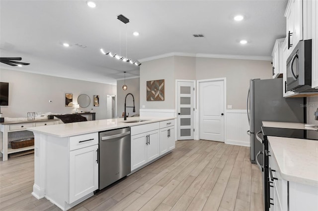 kitchen featuring stove, a sink, visible vents, white cabinetry, and stainless steel dishwasher