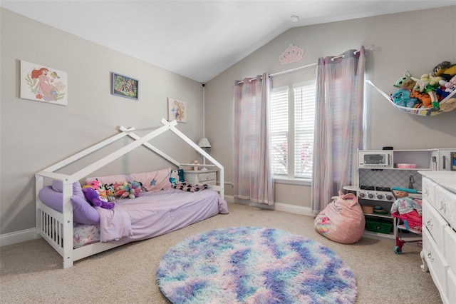 carpeted bedroom featuring lofted ceiling and baseboards