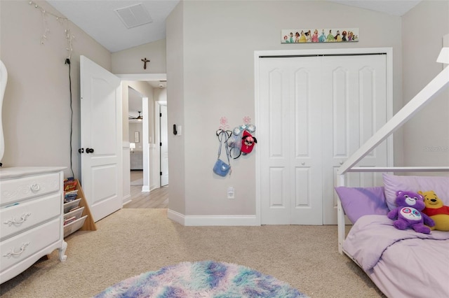 bedroom featuring light carpet, visible vents, baseboards, vaulted ceiling, and a closet