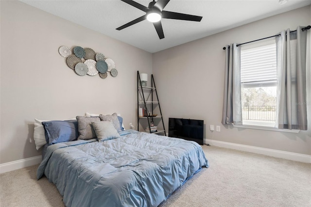 bedroom with ceiling fan, baseboards, and carpet flooring