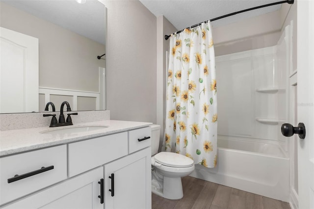 bathroom with shower / bathtub combination with curtain, toilet, vanity, a textured ceiling, and wood finished floors