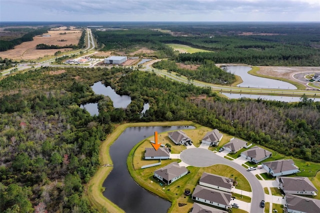 aerial view with a water view and a forest view