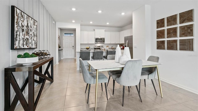 dining room featuring recessed lighting, baseboards, and light tile patterned floors