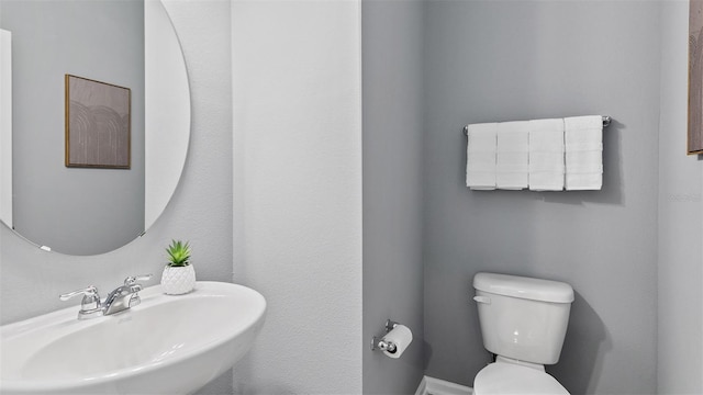 bathroom featuring a sink and toilet